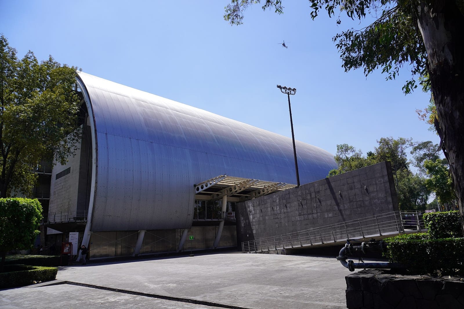 Curved metal-clad building of the Escuela Nacional de Arte Teatral at CENART, Mexico City